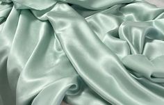 Gorgeous, solid mint green silk with a light shine. One side is shiny, one side is dull.  This fabric makes a beautiful top, Kimono, robe, dress, pajamas...  100% silk, dry clean recommended. Great fabric for apparel. Monitor colors may vary.  Listing is for 1 yard. 36" x 52/53". Wide goods! Light Mint Green Dress, Green Silk Fabric, Mint Green Fabric, Dress Pajamas, Light Green Fabric, Prom Dress Inspo, Charmeuse Fabric, Mint Green Dress, Aqua Mint