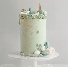 there is a green cake with gold decorations on it