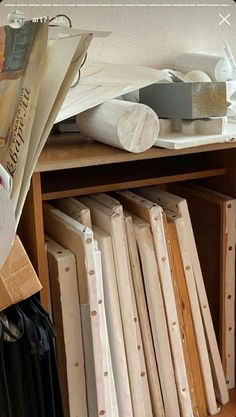 a wooden shelf filled with lots of different types of woodworking tools and paper on top of it