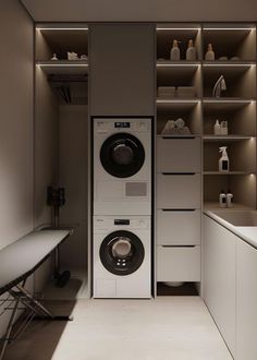 a washer and dryer in a room with shelves on the wall behind them