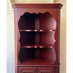 a wooden bookcase with three shelves and two doors