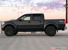 a black truck parked in a parking lot