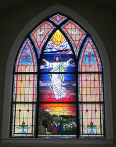 a stained glass window with the image of jesus on it