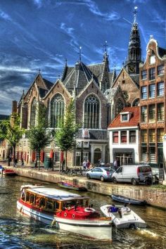 boats are parked on the water in front of buildings