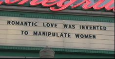 a sign that says romantic love was invented to manipulate women