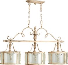 three light chandelier with glass shades hanging from it's arms and sides