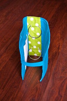 a blue and green bag sitting on top of a wooden floor