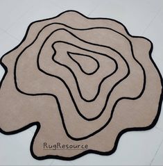 the rug is shaped like a circle and has a black outline on top of it