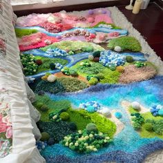 a bed covered in lots of green and blue stuff on top of a white rug