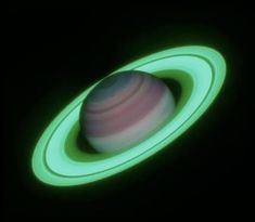 an image of the planet saturn taken from space with green light on it's side