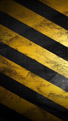 a yellow and black hazard sign on the side of a road that has been painted