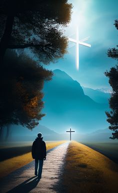 a man walking down a road towards a cross