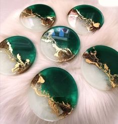 six green and gold marble coasters on a white furnishing