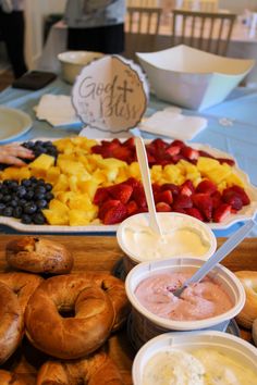 an assortment of pastries and dips are on display at a buffet style party