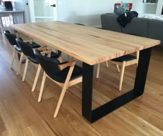 a large wooden table with black chairs around it