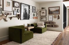 a living room filled with furniture and pictures on the wall