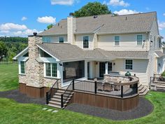 this is an aerial view of a house with stone and wood accents on the front porch