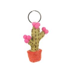 a cactus keychain with pink pom - poms hanging from it's side