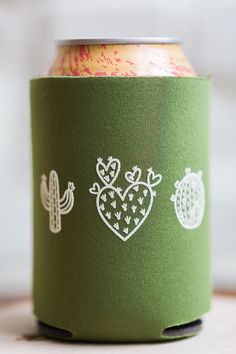 a can cooler with cactus, heart and cacti stencils on it