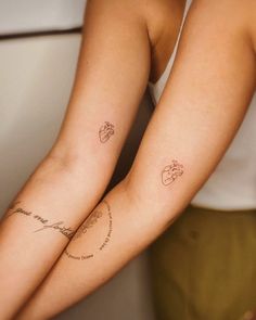 two people with matching tattoos on their arms