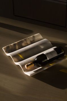 a bottle of wine sitting on top of a tray