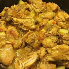 chicken and vegetables are being cooked in a skillet