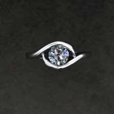 a ring with a diamond in it on a black background