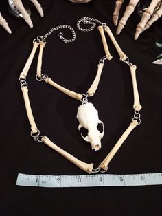 Have a Look at This Beautiful Mink Skull Necklace! It was Made With 10 Real Coyote Bones, with Silver Tone Hardware and Chain. It is Adjustable up to 24 Inches. All Items Ship Within 1-3 Days via USPS First Class Service. Shipping on This Necklace is FREE (USA Only) All Bone Jewelry Orders Over 35 USD $ Ship for FREE. ( USA Only ) International Shipping Will Be 20.00, And All Additional Items Add 1.00 to the Shipping Cost. International Shipping May Take 2 - 4 Weeks To Deliver. Please Note : We Animal Bone Jewelry Clay, Halloween Skull Jewelry In Bone Color, Halloween Skull Shaped Bone Jewelry, Real Bone Jewelry, Animal Bone Jewelry, Cicada Necklace, Taxidermy Jewelry, Real Skull, Wiccan Necklace