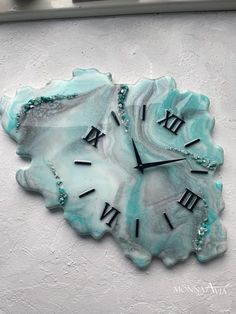 a clock with roman numerals on the face of a piece of blue agate