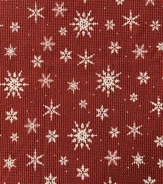 a red and white snowflaked fabric with small white snow flakes on it