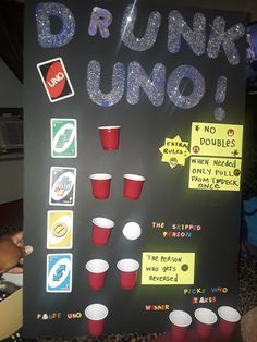 a sign that says drunk uno with cups and sodas on it's side