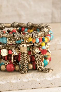 Elegant bohemian-inspired stretch bracelet featuring multi-layered, colorful mixed wood, stone, and metal beads. The combination of textures and hues gives this bracelet a unique and eye-catching look. Made with acrylic, wood beads, and zinc, this bracelet is also nickel/lead compliant for added safety. Measuring approximately 9.25 inches in length and 2.5 inches in diameter, this bracelet will add a touch of boho-chic to any outfit. Imported for the highest quality. Memory Bracelets, Wood Beads Jewelry, Classy Yet Trendy, Material Ideas, Jewerly Designs, Memorial Bracelet, Inspirational Bracelets, Bohemian Bracelets, Wood Stone