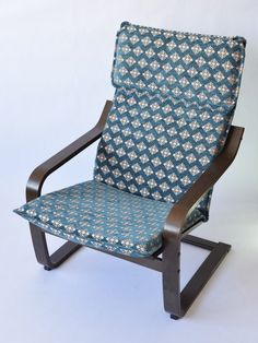 a blue and white patterned chair with wooden frame