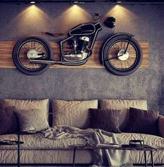 a motorcycle is mounted to the wall above a couch