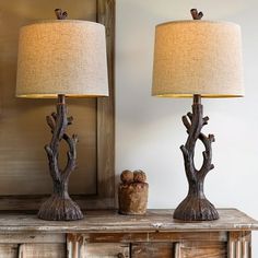 two lamps sitting on top of a wooden table