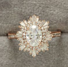 an engagement ring with a large diamond surrounded by smaller diamonds