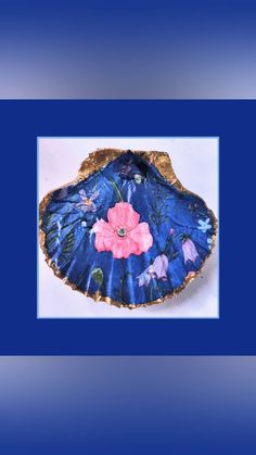 a blue and gold plate with flowers on it