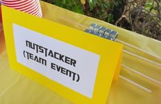 there is a yellow sign that says mustjacker team event on it and some sticks sticking out of it