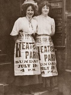 two women in aprons standing next to each other