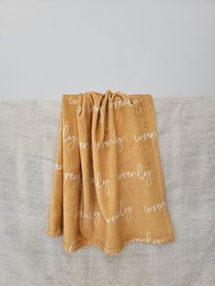 a tan and white blanket with words on it