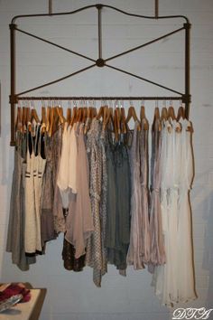 an iron rack with clothes hanging on it