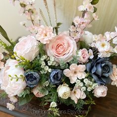 a vase filled with lots of flowers on top of a table