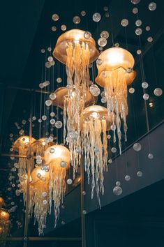 a chandelier hanging from the ceiling in a room with many lights on it