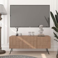 a large flat screen tv mounted to the side of a wooden cabinet in a living room