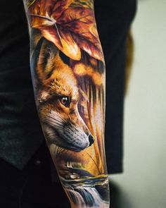 a man's arm with a fox and leaves on it