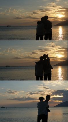 two people standing next to each other in front of the ocean at sunset or dawn