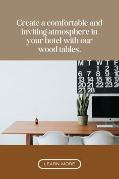 a desk with a computer on top of it next to a plant and calendars