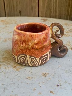 a ceramic cup sitting on top of a table