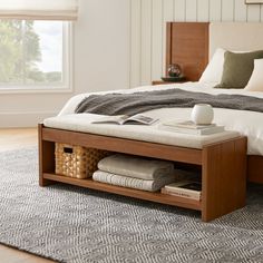 a bed with a wooden frame and storage underneath it