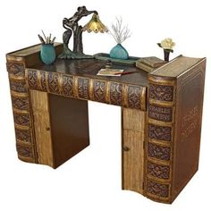 an antique desk with books and vases on it